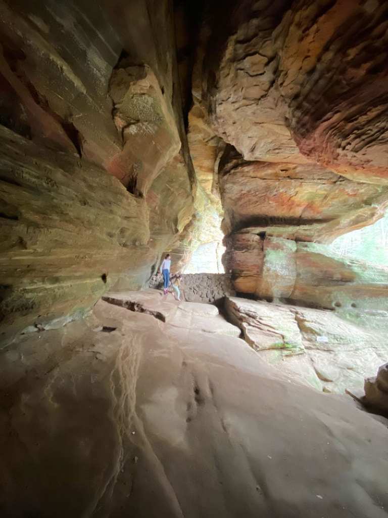 My daughers inside Rock Cave in Hocking Hills Ohio--you can just see a large rock enclosure all around them but open on the right... and they look pretty small compared to the cave. 