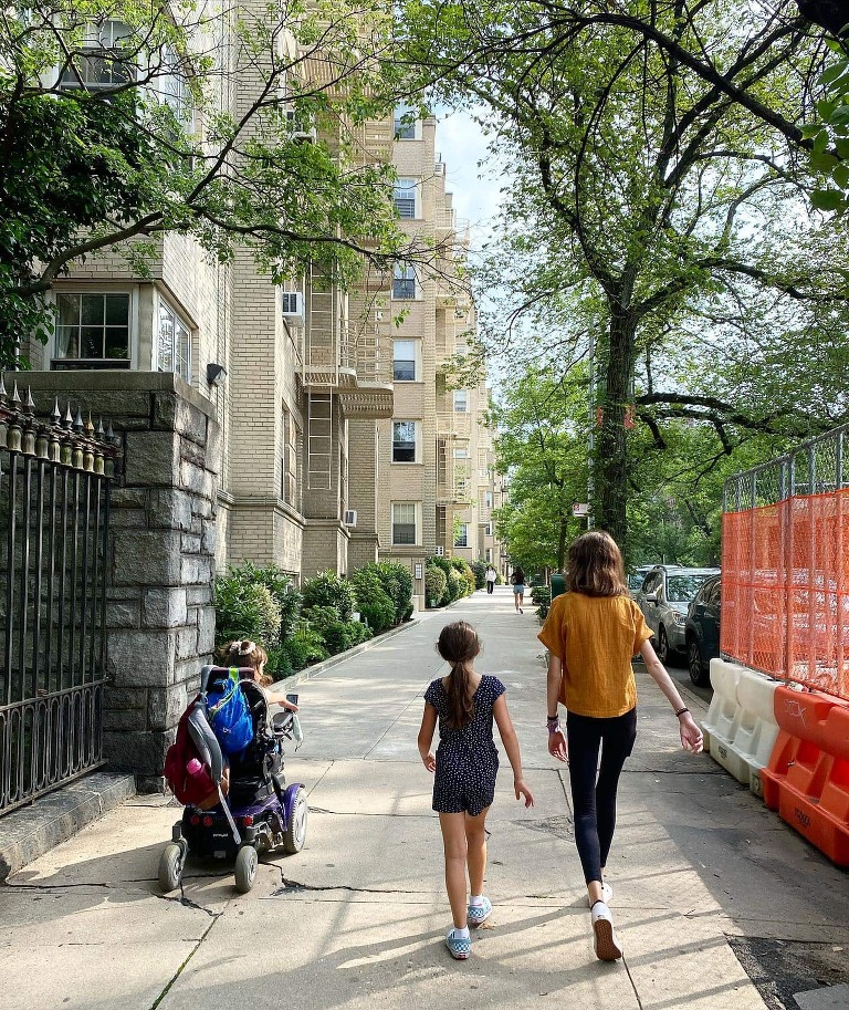A photograph of my three daughters from behind, walking down the streets of New York City--two of them are ambulatory, while one daughter is in a wheelchair. 